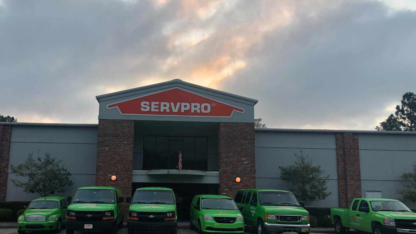 SERVPRO of Greater Covington and Mandeville's green vehicles parked in front of Mandeville office.