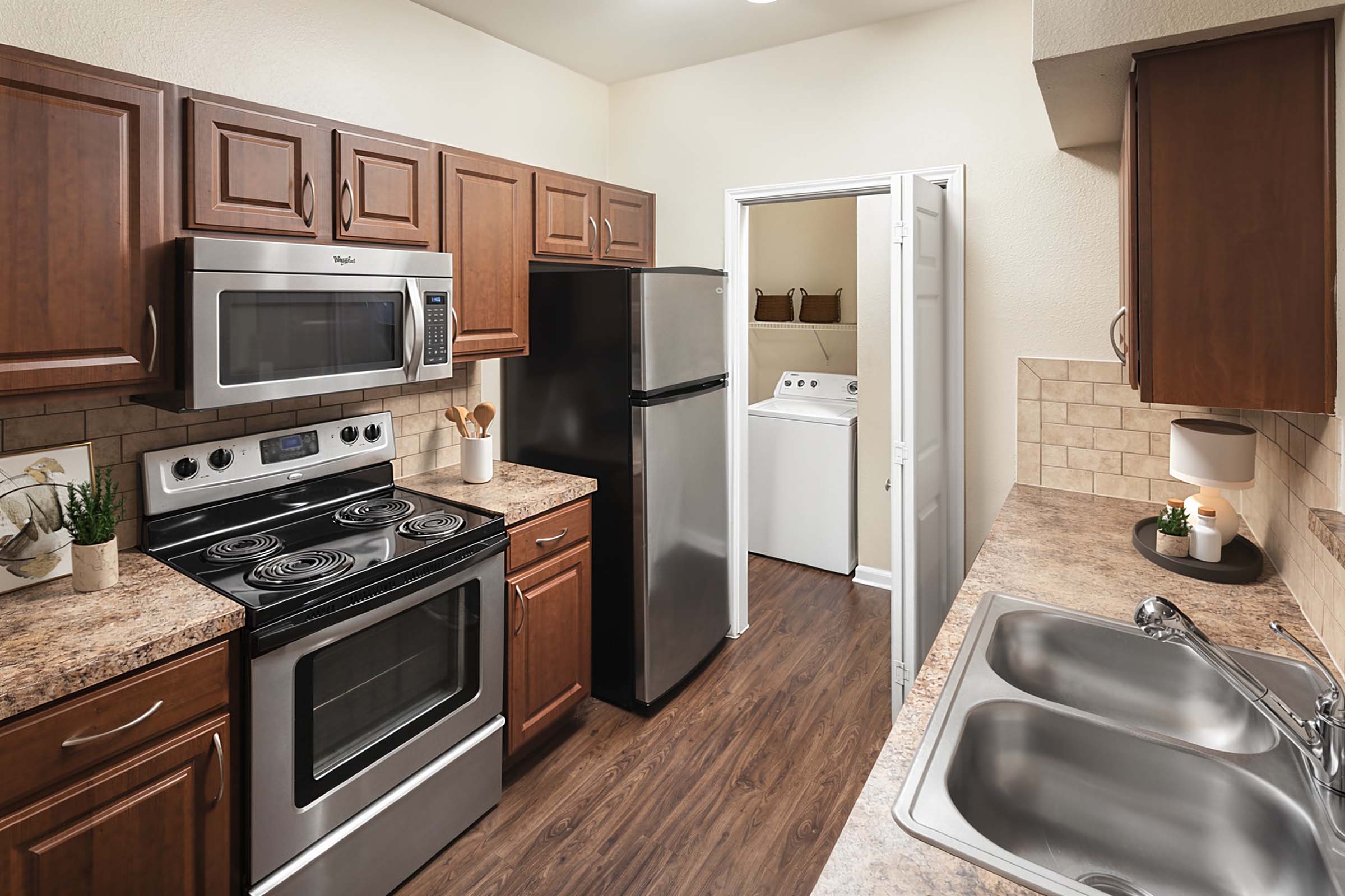 Laundry room with stainless steel appliances and laundry room at Camden Buckingham apartments in Ric 