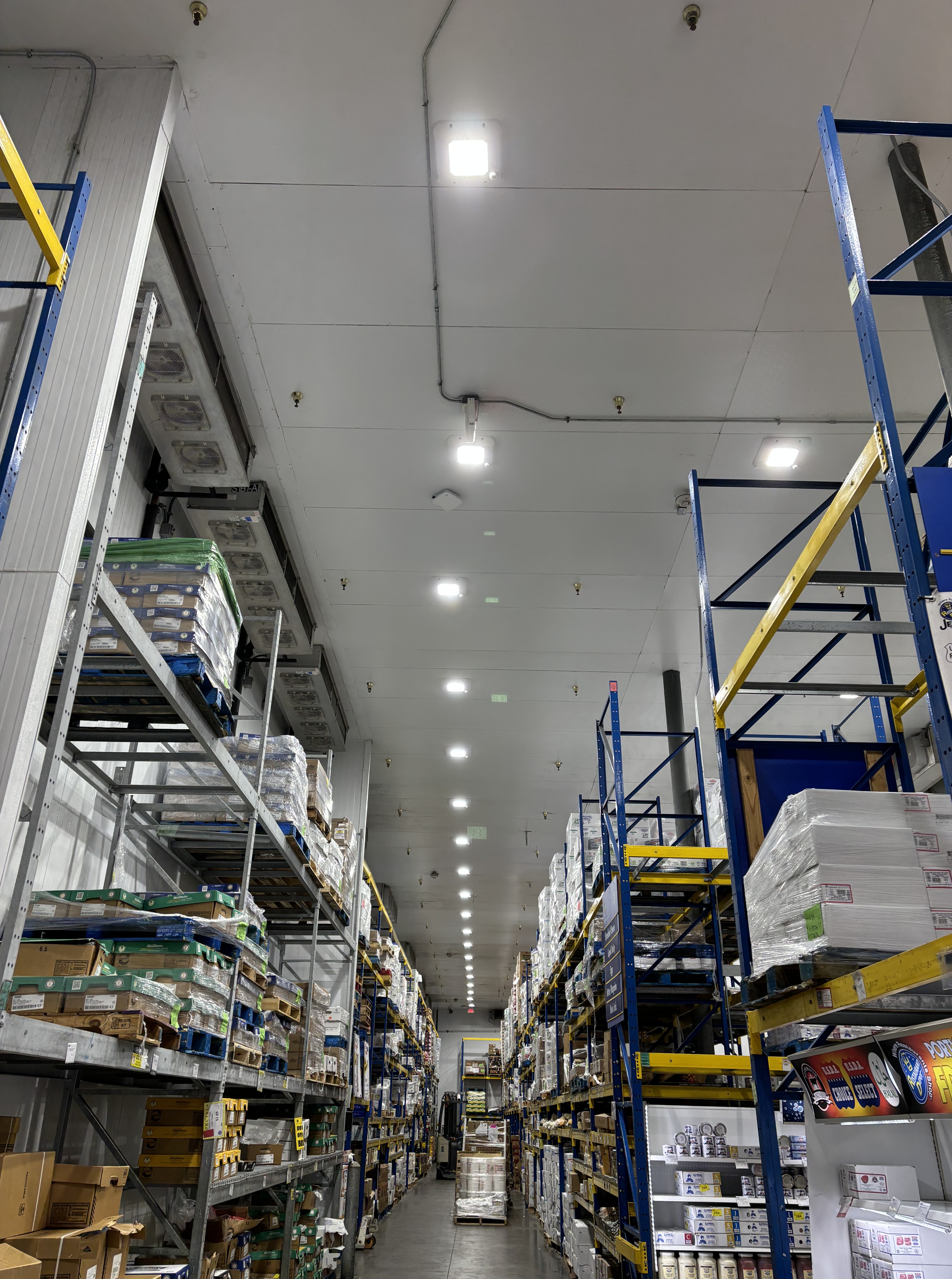 High-quality industrial lighting installation in a spacious warehouse. Designed for durability and efficiency, our electrical services enhance safety and visibility for large-scale operations.