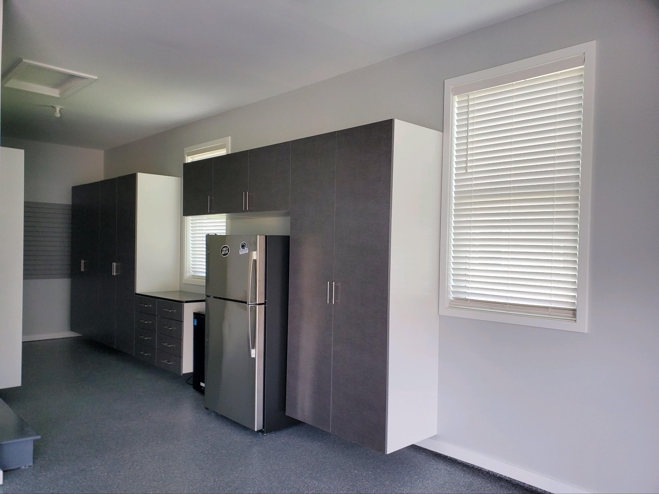 A complete garage makeover.  Fresh paint.  A high performance Gray's Peak Epoxy flake floor.  Custom cabinets.  Some complete with Windswept Pewter finish doors, dovetail maple drawers, and gray slatwall with accessories completes this garage in State College