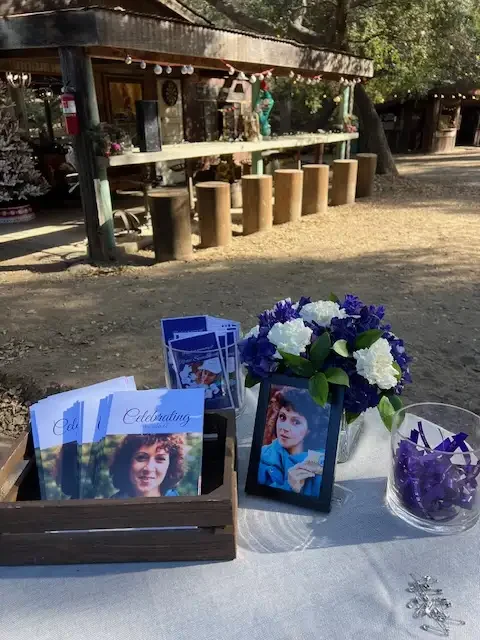 Outdoor reception scene with personalized lanterns and guest book table