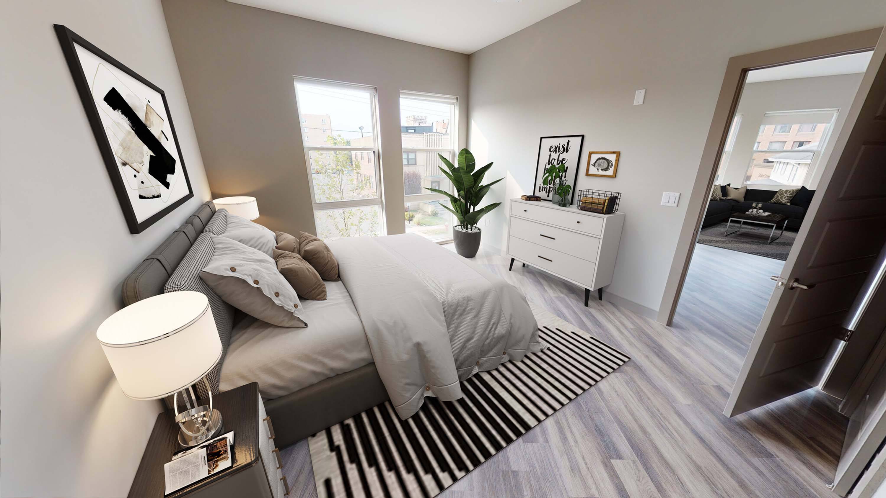 A bedroom with a bed, nightstand, and a plant