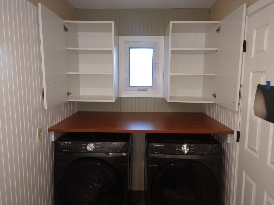 New custom laundry area with countertop and cabinets in Millheim, PA