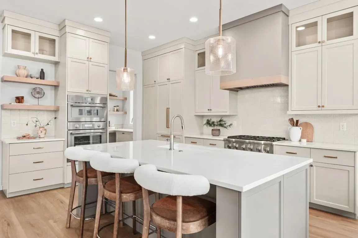 The chef&rsquo;s kitchen includes a Thermador gas and electric appliance package, full tile backsplash, oversized prep island, and custom cabinetry.