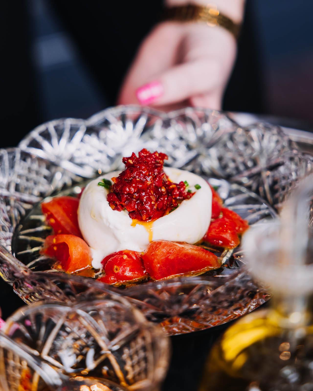 Burrata with roasted tomatoes, pesto and extra virgin olive oil