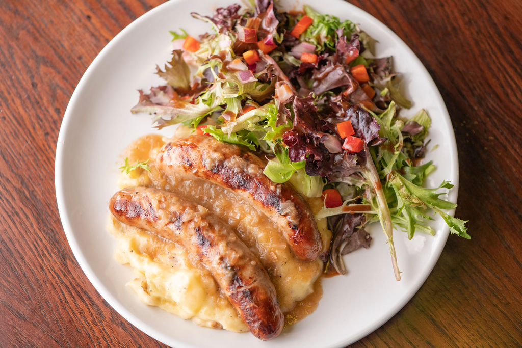 char-grilled sausages, Old Speckled Hen Ale onion gravy, smashed potatoes, accent salad