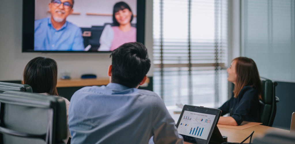 An advisor team meeting with clients over video call.