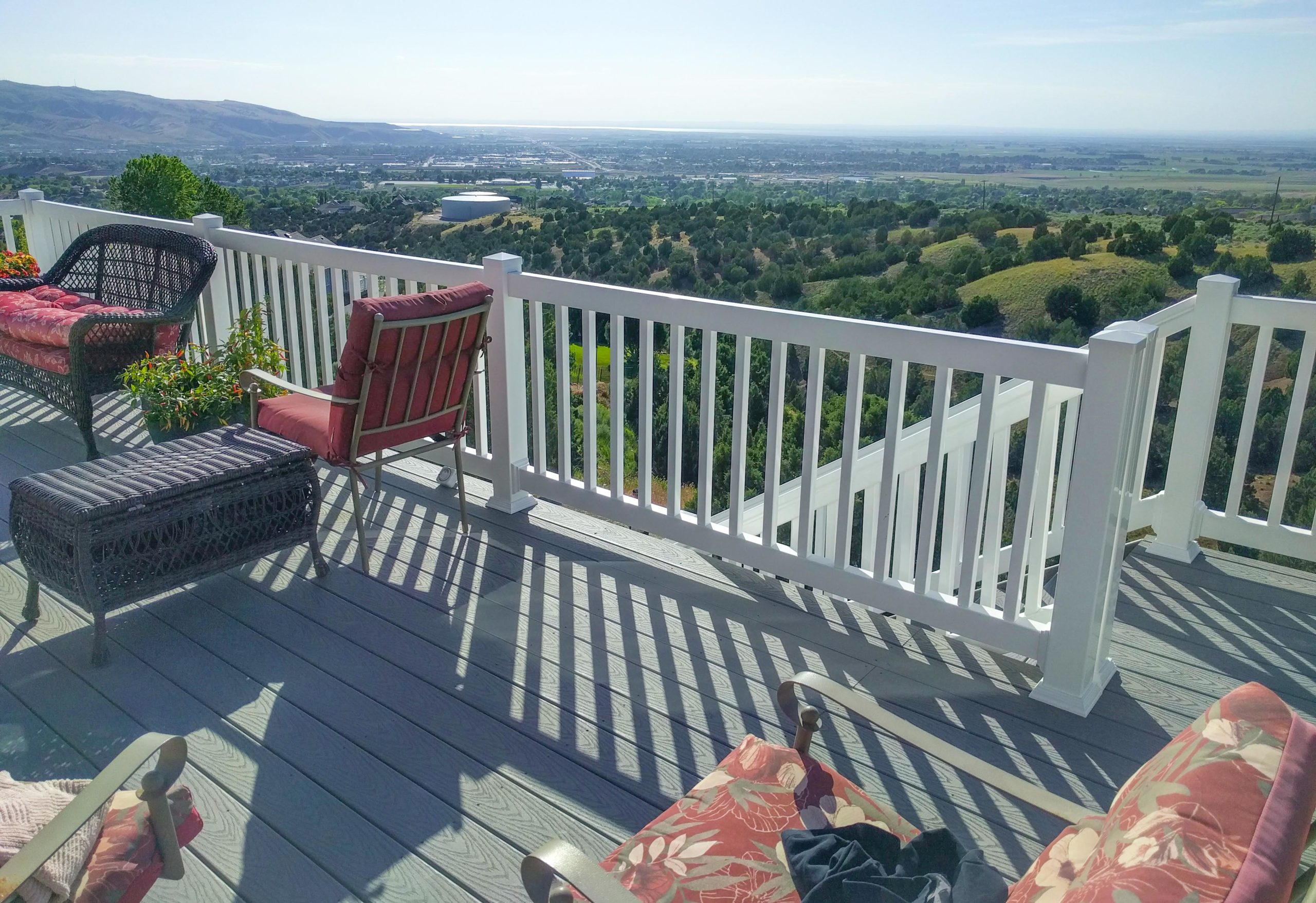 Enjoy breathtaking scenery from your own backyard. This custom composite deck by DeckPro LLC features durable, low-maintenance materials and clean white vinyl railing designed to maximize the stunning views of the Snake River Valley.