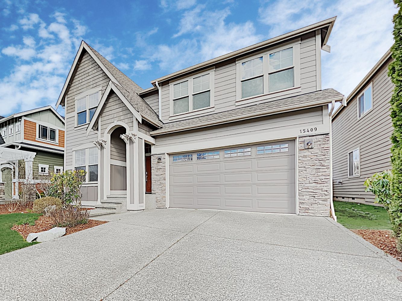 Charming home with two-car garage and covered porch entrance at Invitation Homes Seattle.