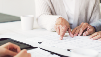 Close-up of people reviewing documents.