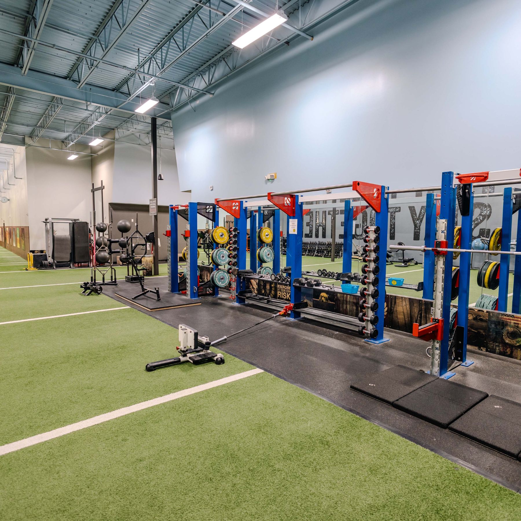 Strength training at our Richmond gym featuring Olympic racks, free weights & turf space for functional lifts &mdash; ideal for the best strength training in Richmond.