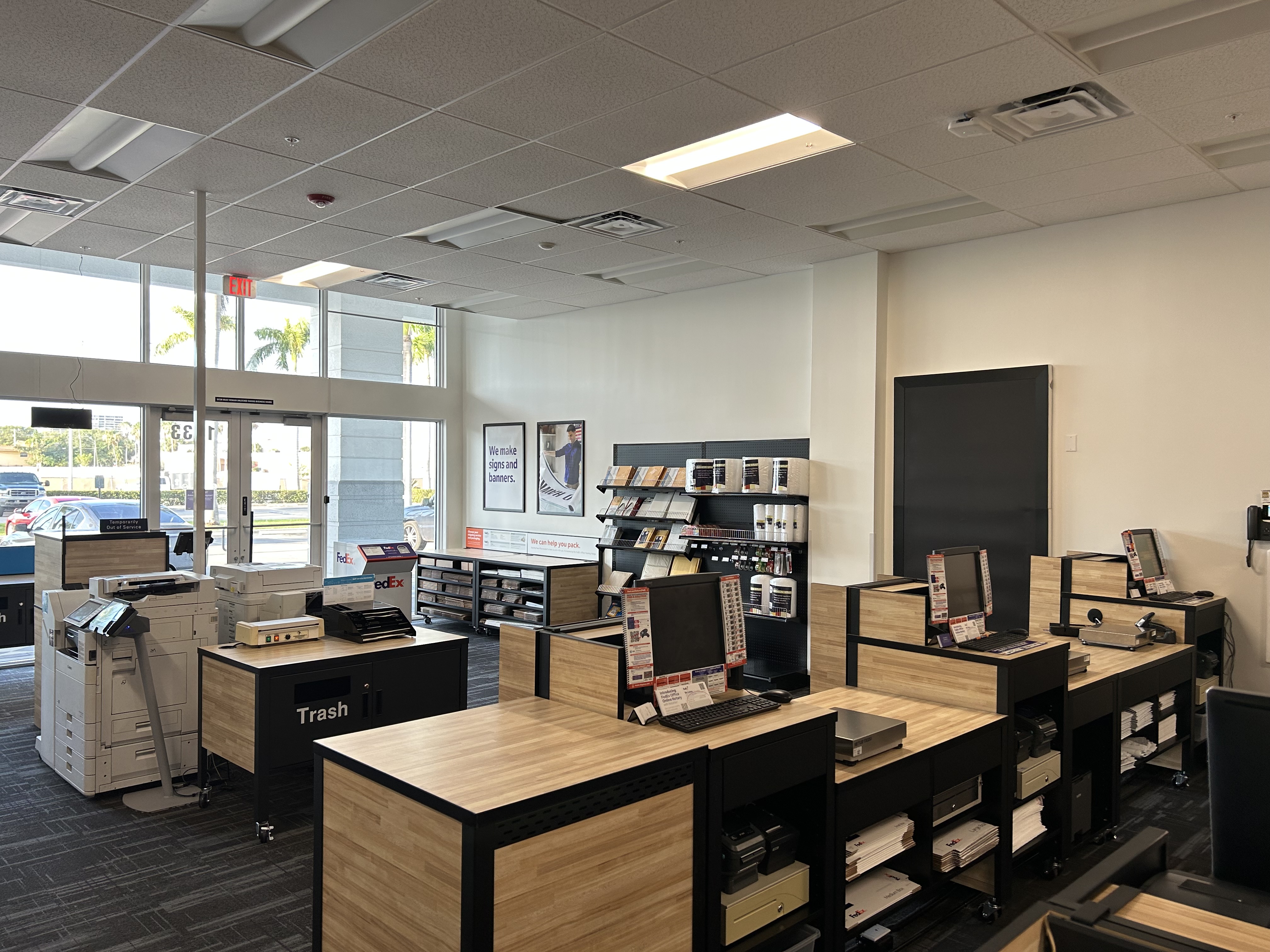 Self-service printing and computer workstation area at FedEx Office in North Miami FL with printers, internet access, and document services.