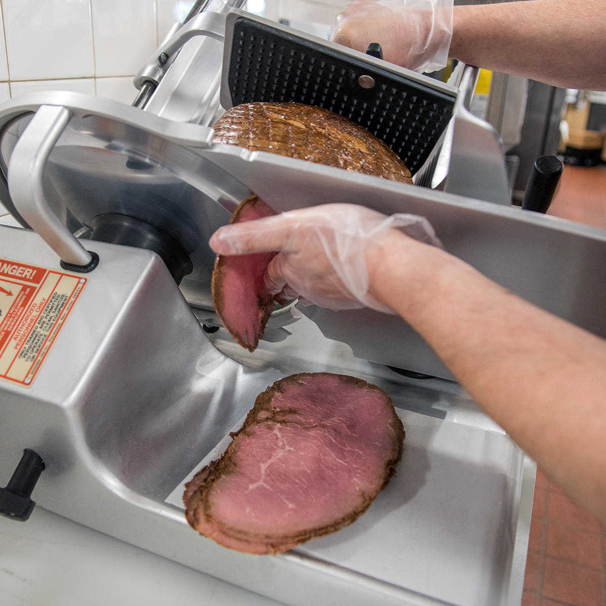 Tight shot of associate operating deli slicer. Stop & Shop Washingtonville (845)496-8656