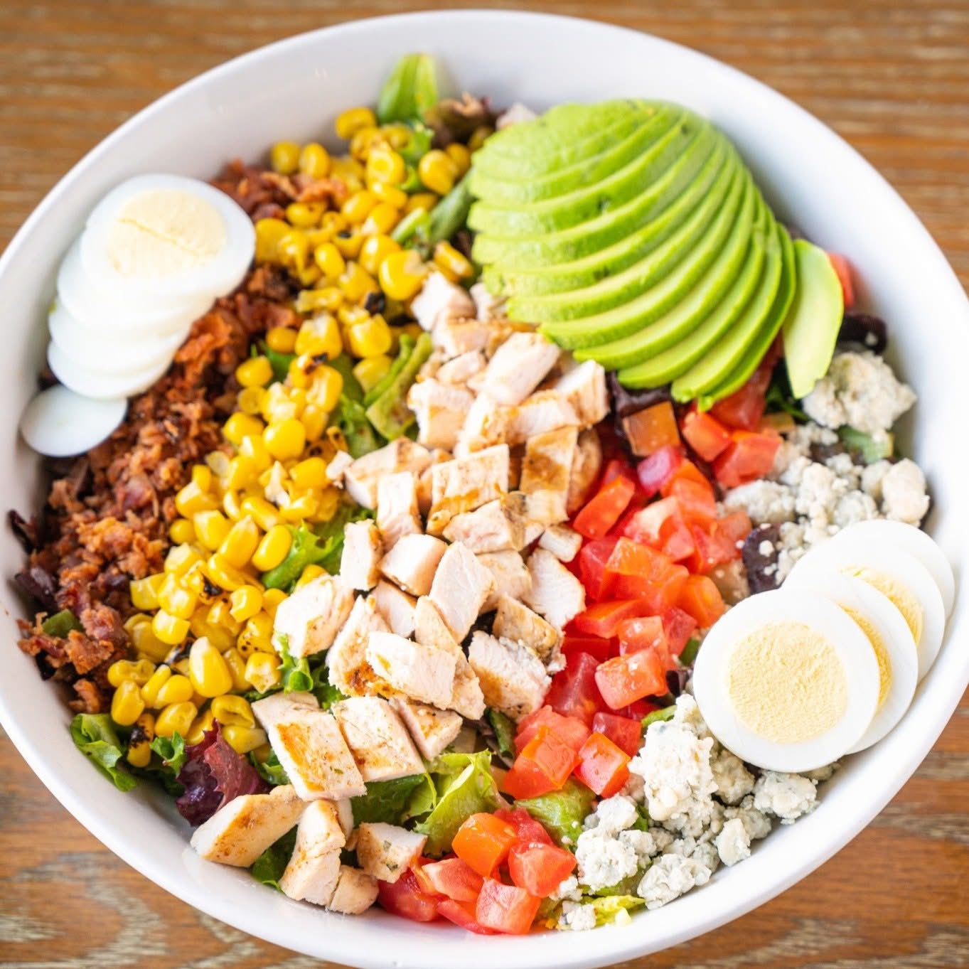 Grilled chicken | Roasted Corn | Bacon | Tomatoes | Bleu Cheese Crumbles | Avocado | Hardboiled egg  