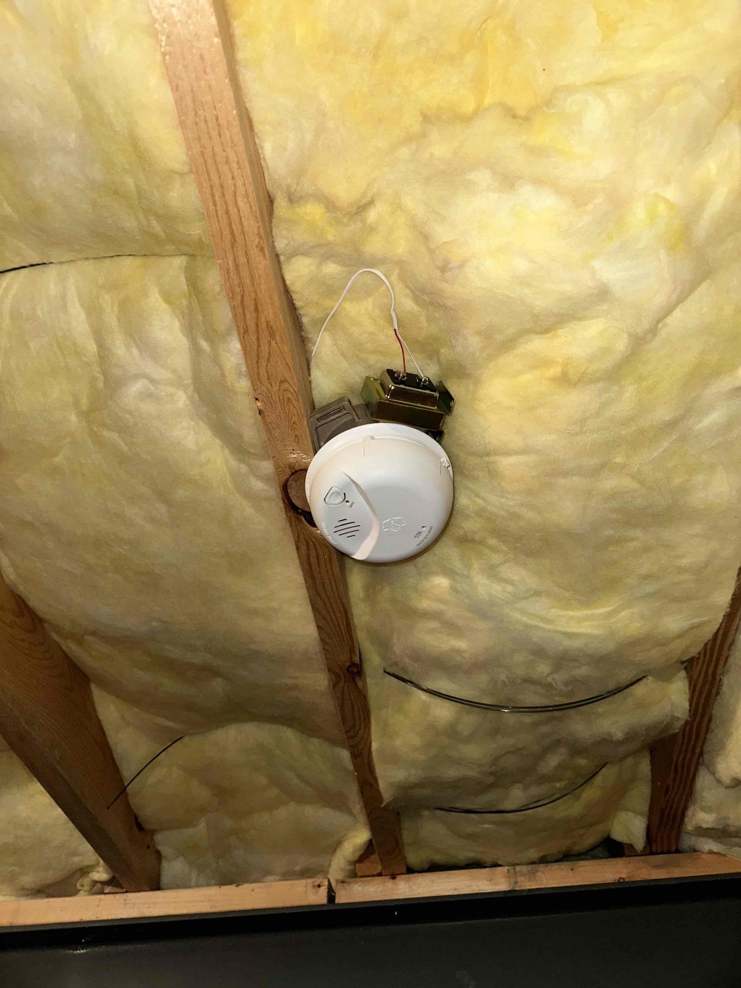 Thomas Edison Electric installed a hardwired smoke detector with battery backup in the ceiling joists of a Lebanon, PA home. The unit is wired to a junction box and interconnected with the rest of the home's detector system for whole-house alerting.