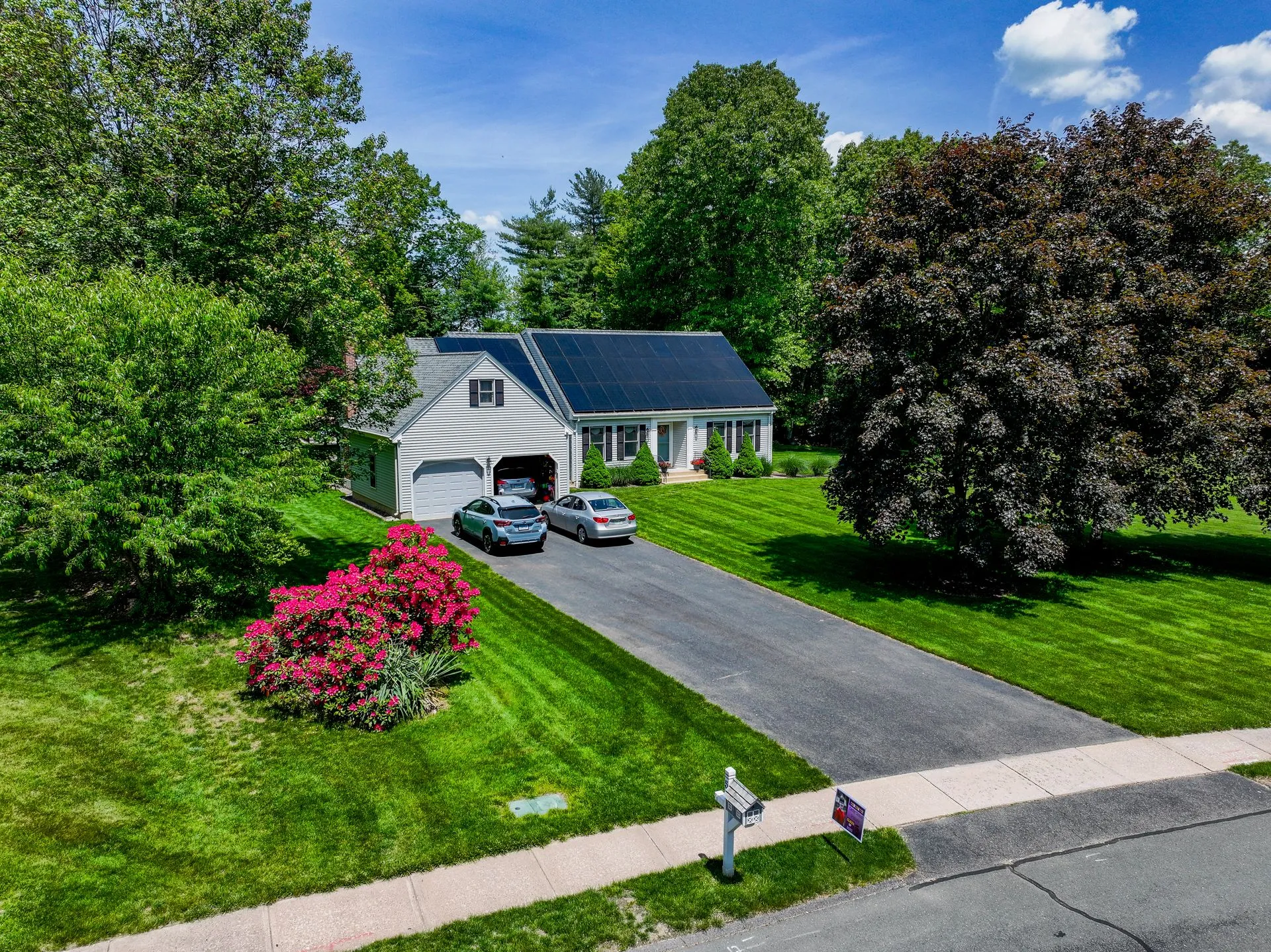 Suburban home with completed solar installation and landscaped yard
