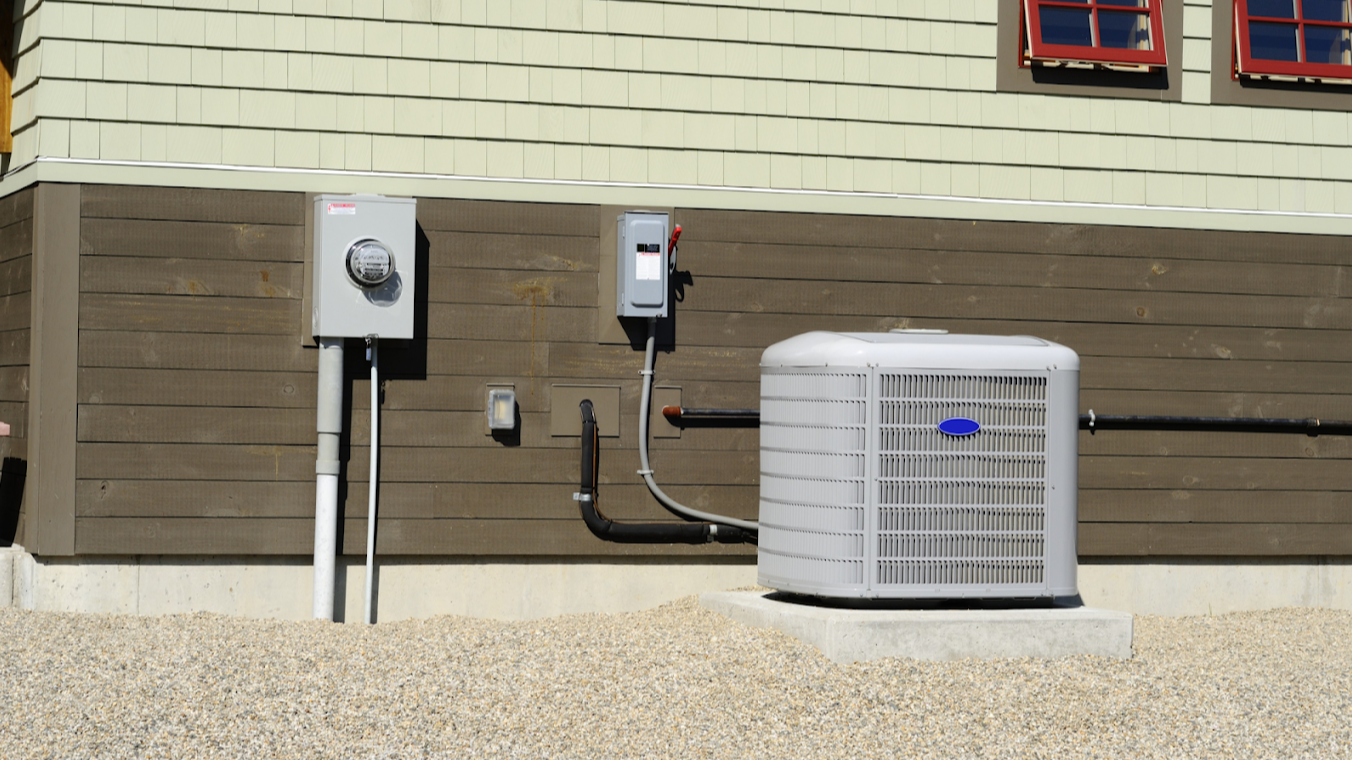 High-efficiency residential HVAC unit installed on a concrete platform outside a home, ensuring optimal heating and cooling performance. Professionally connected to the electrical and piping system for energy-efficient climate control. MAX Comfort HVAC specializes in expert HVAC installation, repair, and maintenance services in Allentown, PA, delivering reliable and cost-effective solutions for homes and businesses.