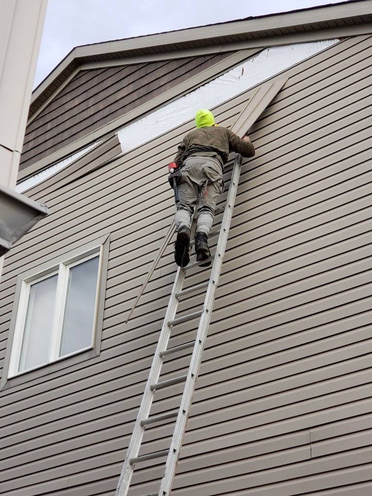 man completing a siding installation service