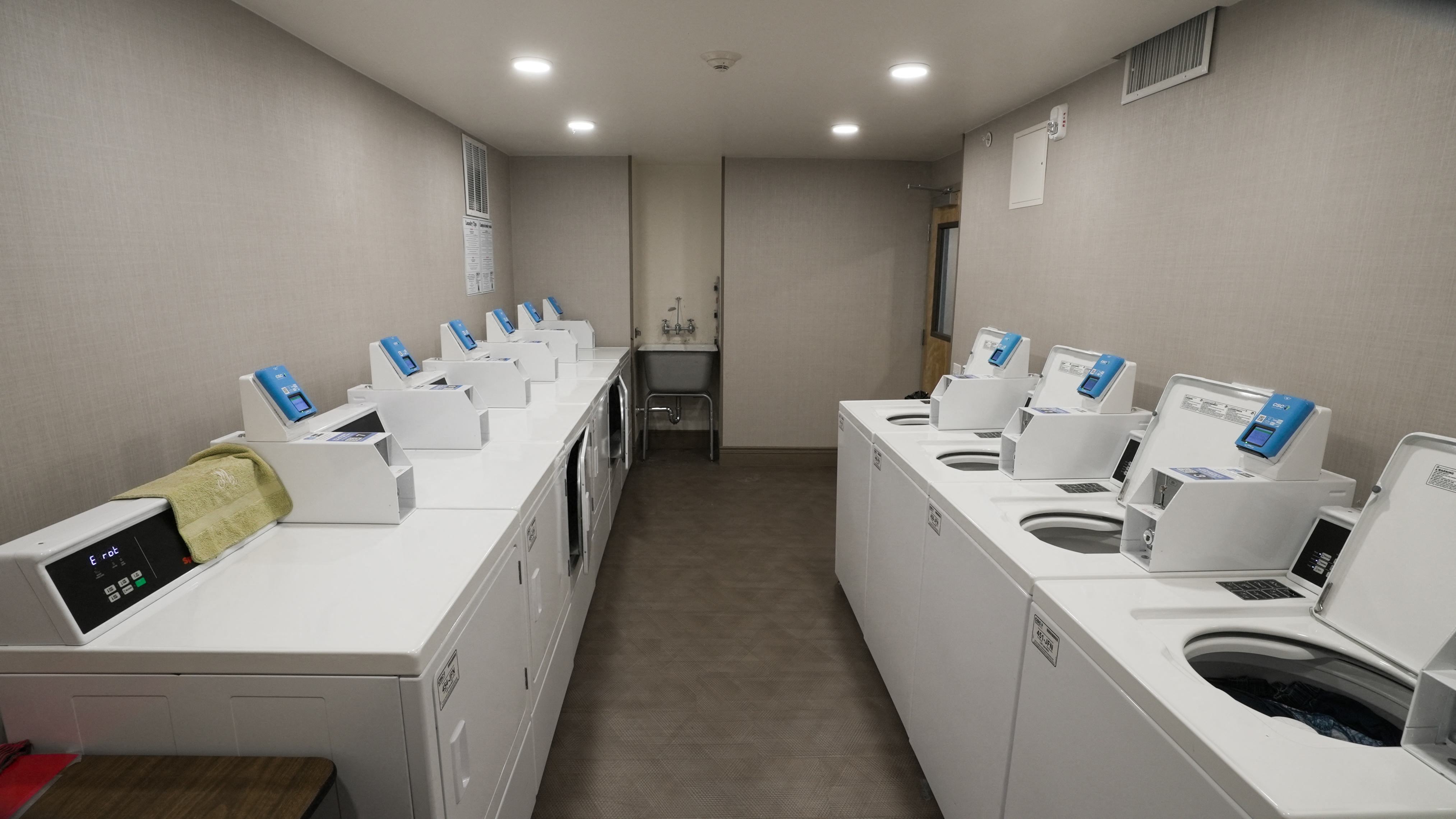 A laundromat with rows of washers and dryers