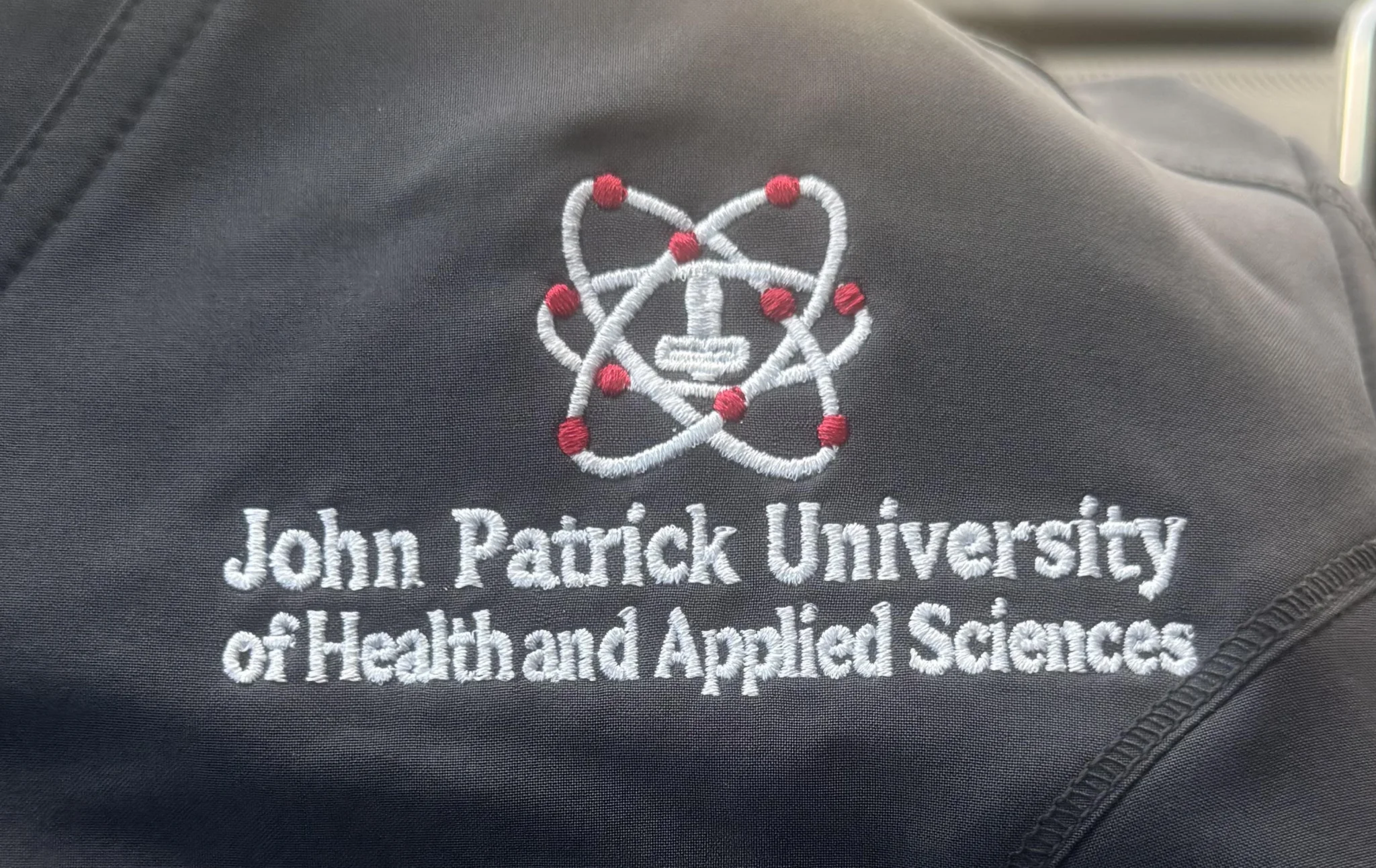 John Patrick University clothing logo