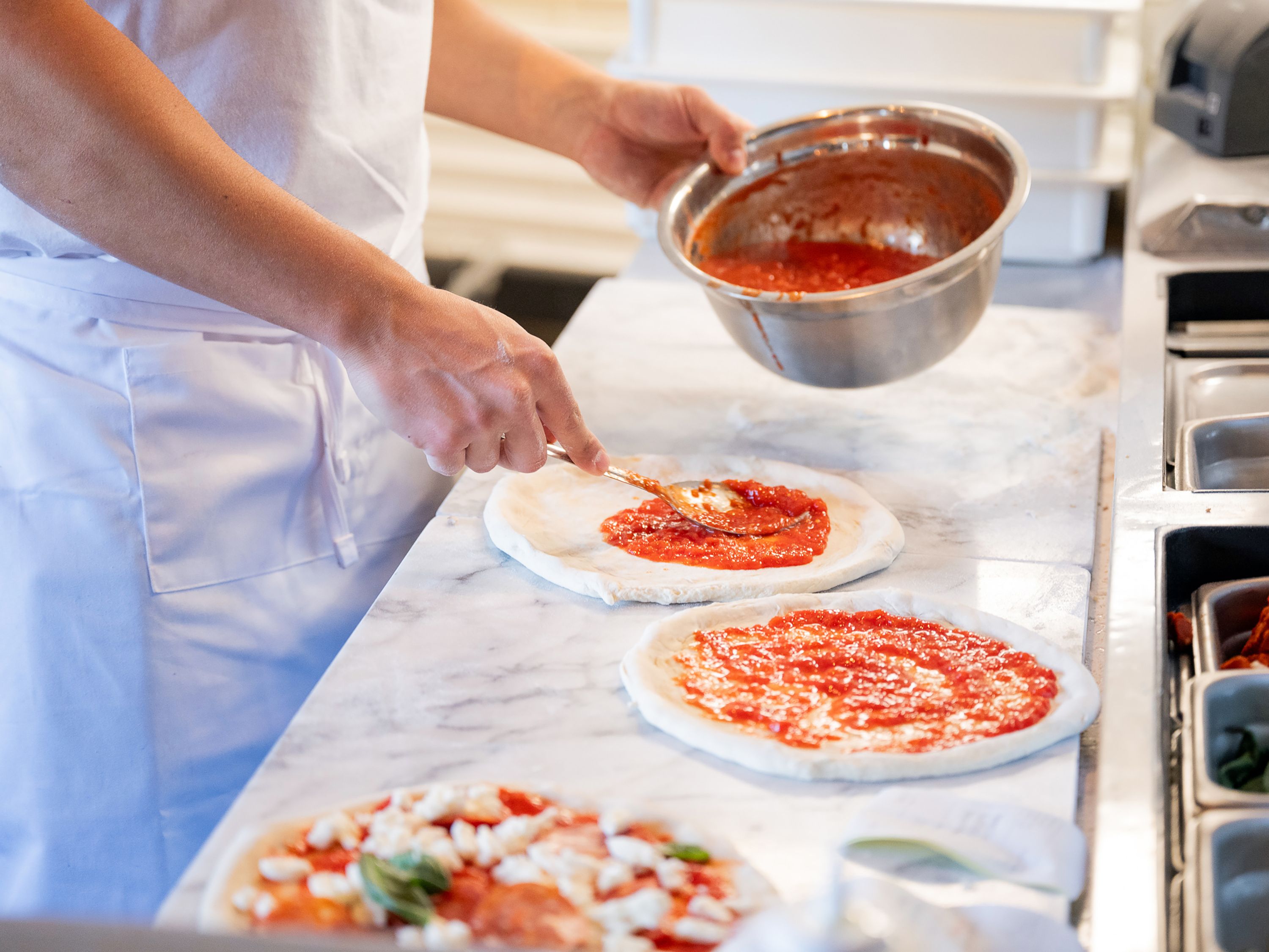 Pizzaiolos making pizza