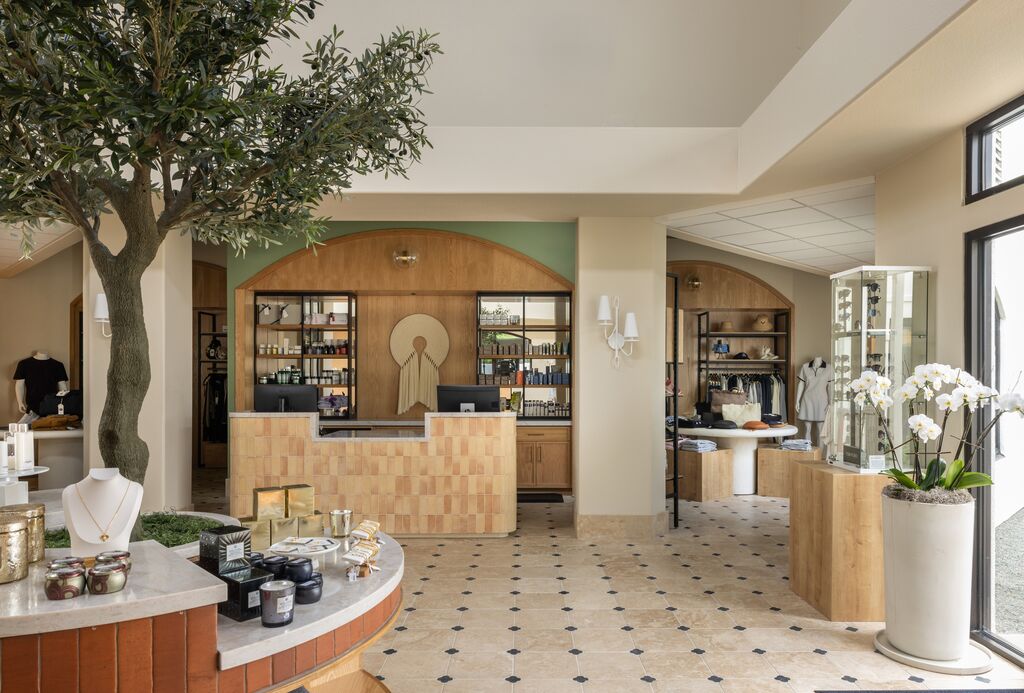 An olive tree, soaring ceilings, and a curated retail display — your Napa wellness day begins the moment you walk through the door.