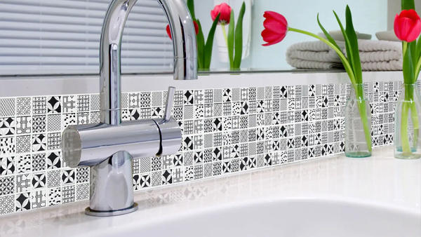 monochrome mosaic tiles adorn a sink splash back in bathroom