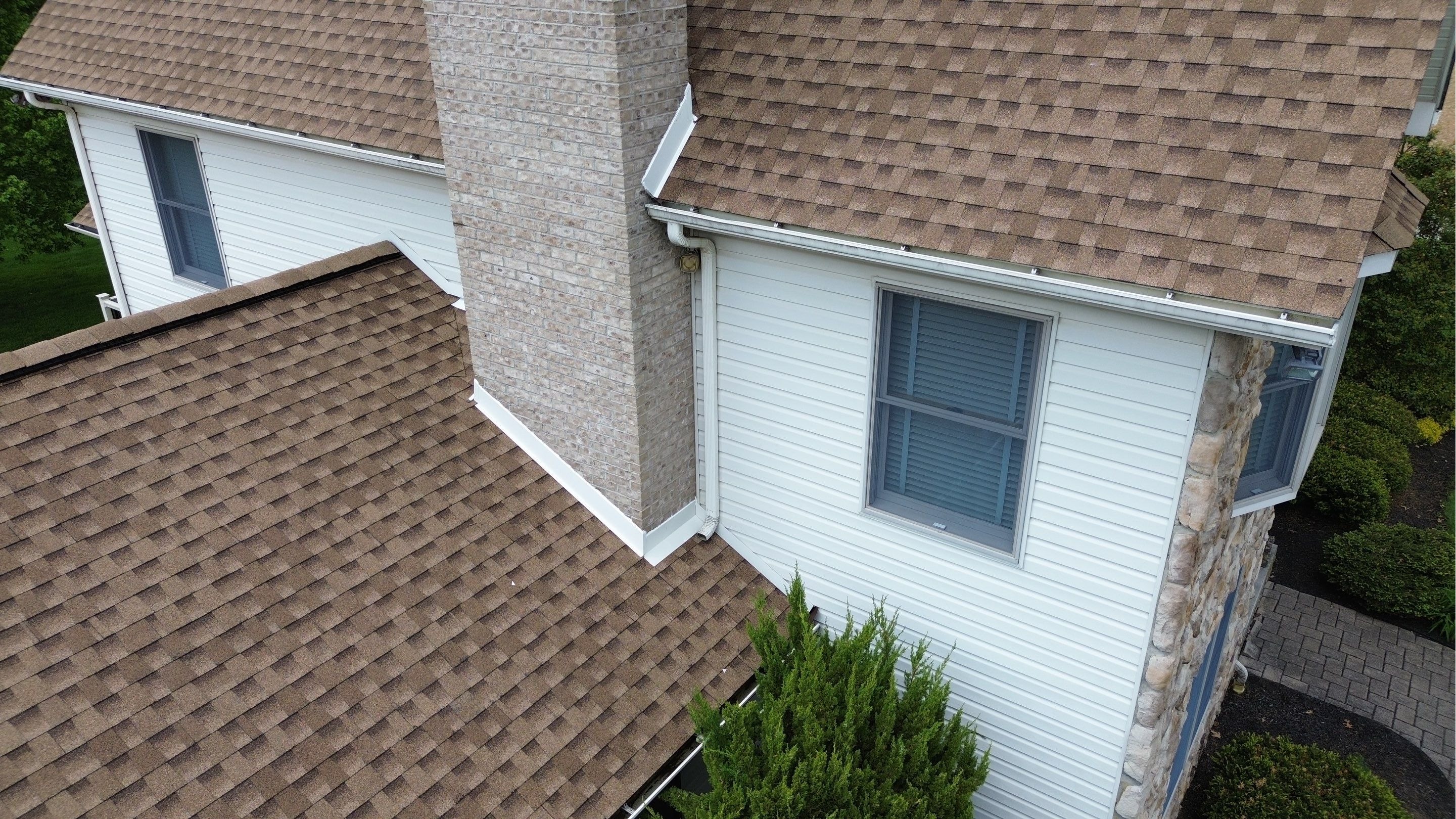 Close-up of completed chimney flashing on an architectural shingle roof in Westminster, Maryland, sh 