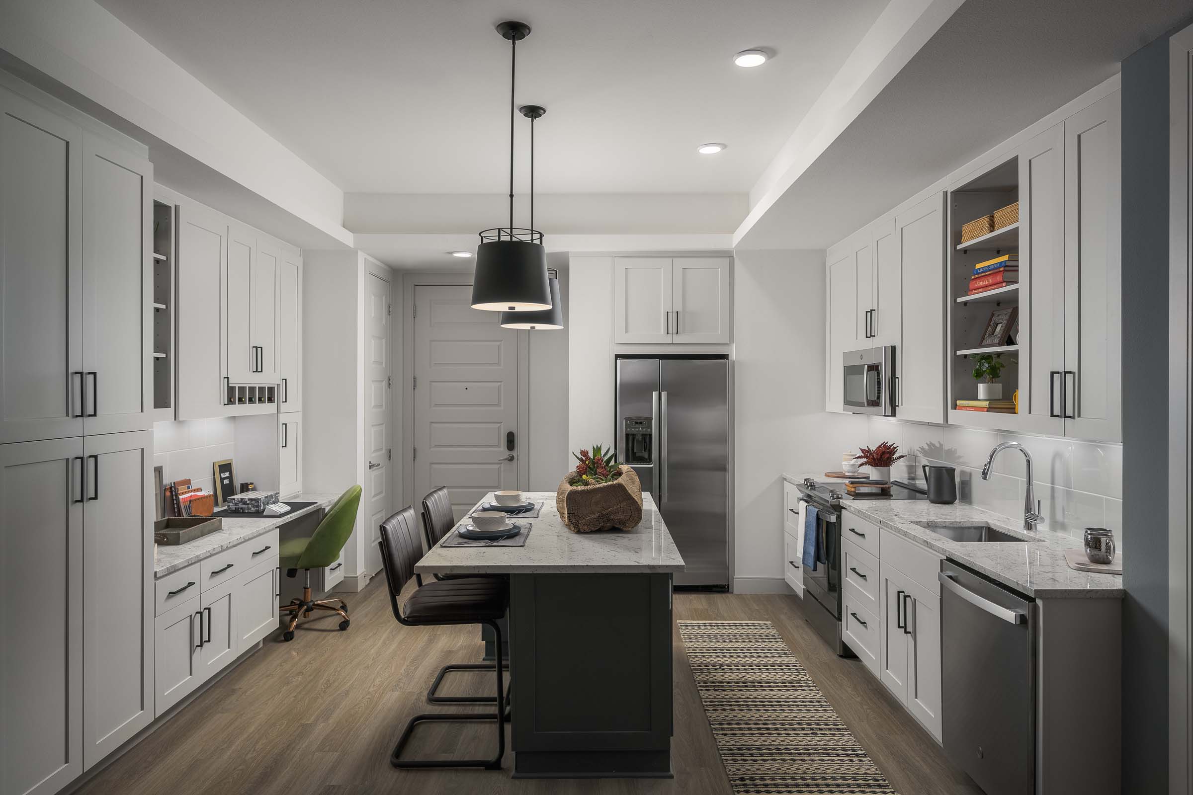 Kitchen with island and built-in desk at Camden Gilbert apartment homes in Gilbert, AZ