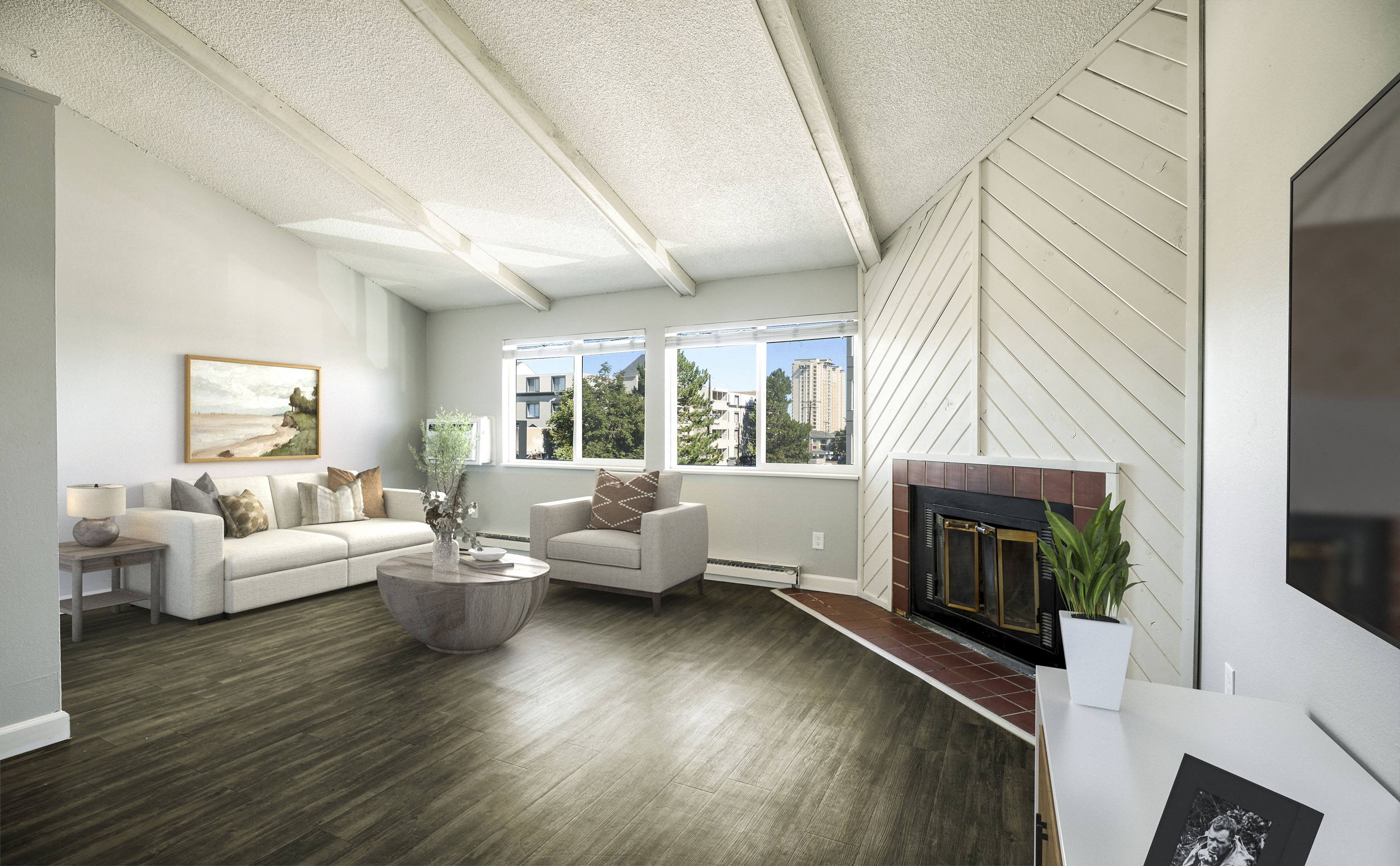 a living room with white furniture and a fireplace 