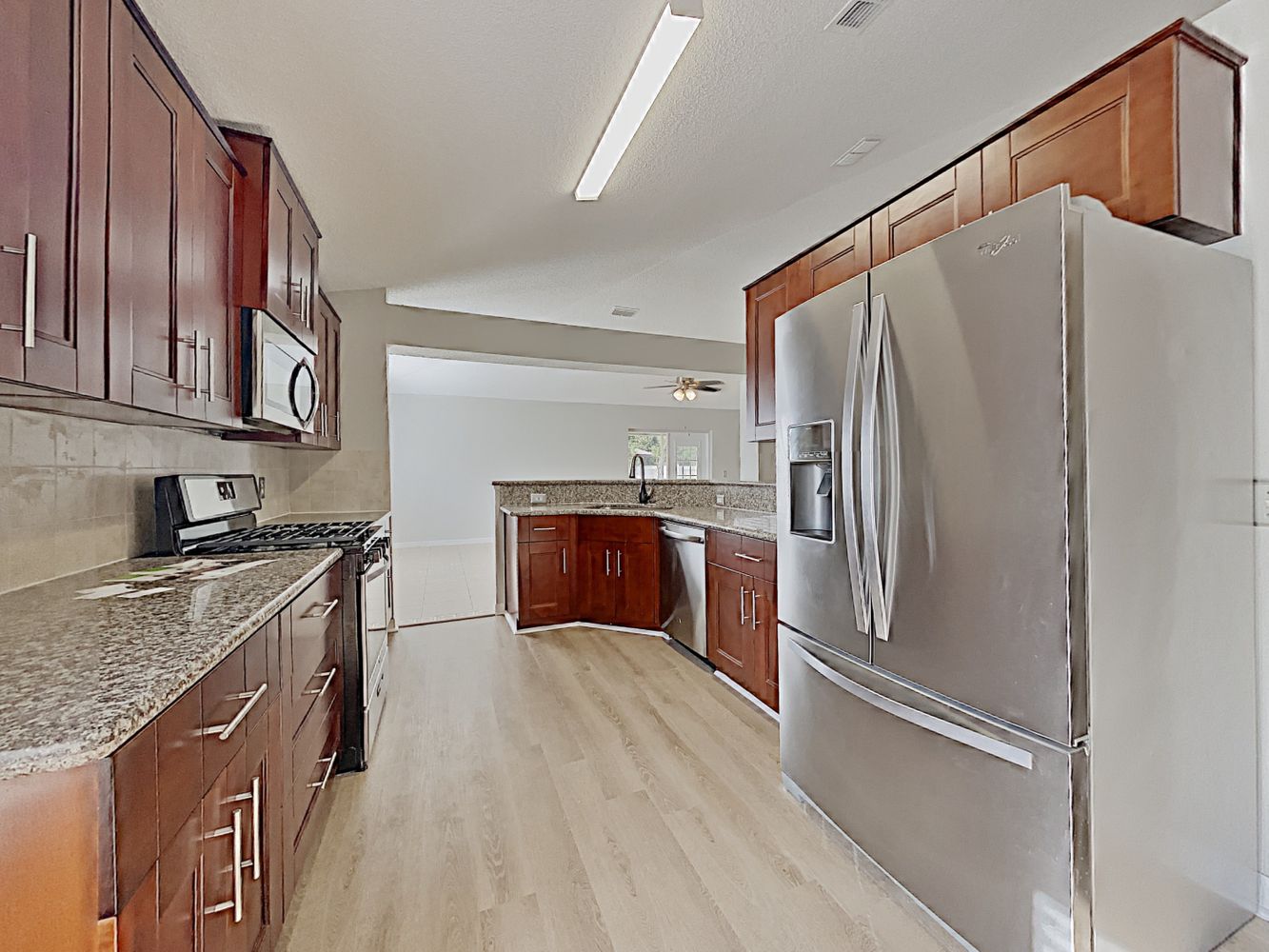 Spacious kitchen with stainless steel appliances and plenty of storage at Invitation Homes Jacksonville.