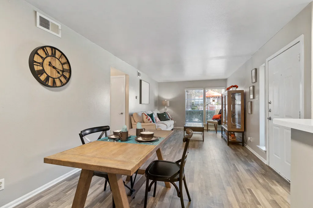 Open concept living and dining area with wood style flooring