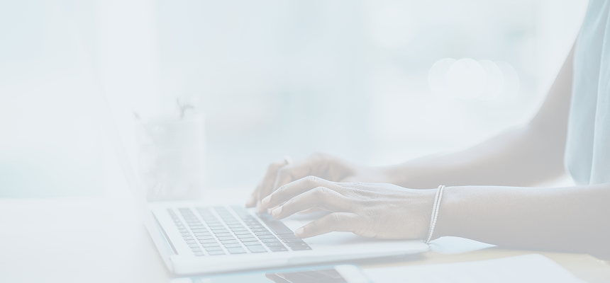 Woman's hands at laptop keyboard.