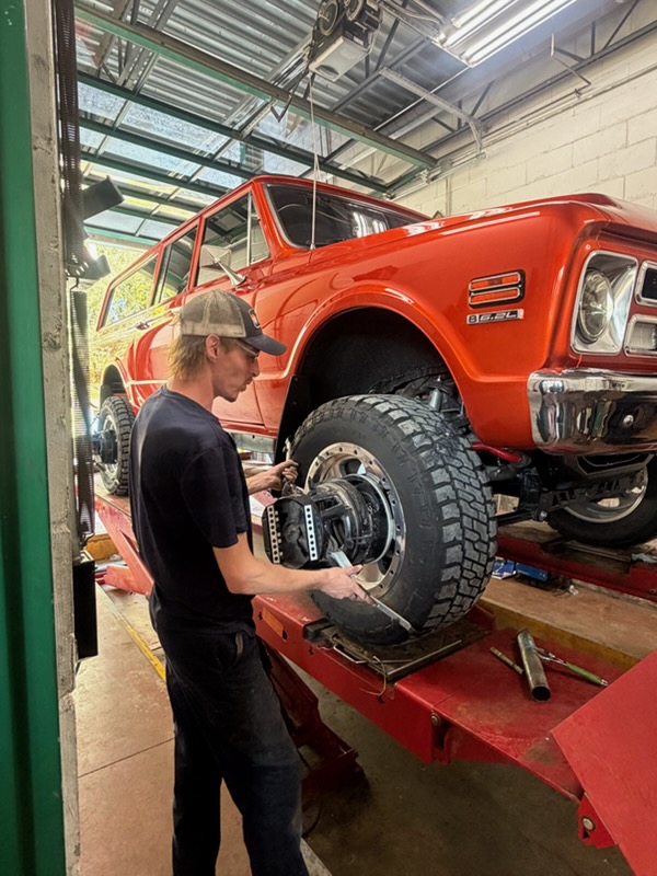 Walker Tire Point S technician performing tire and wheel service at our 48th & Pioneer location in Lincoln.