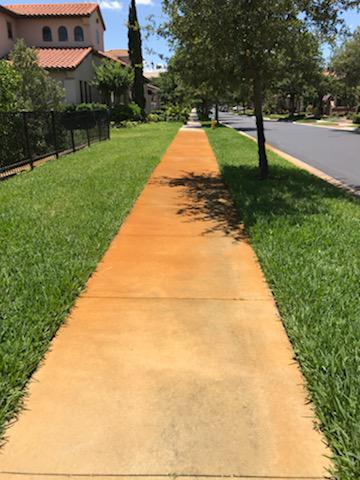 Sidewalk with rust stains before Rust Off treatment