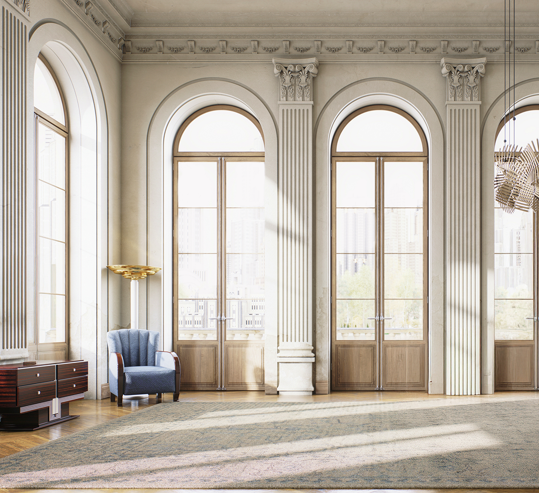 A large ballroom with decorative columns, crown molding, and arched, oak windows.