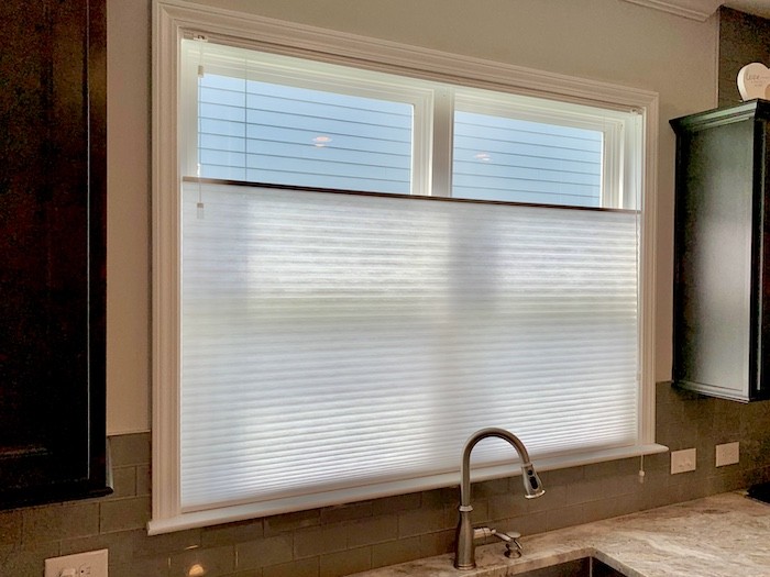 Create a sleek ambiance with our gorgeous cellular shades! Our cellular shades offer the perfect balance of style and functionality to seamlessly elevate any space, just like this local Hilton Head Island kitchen. Choose from our various light filtering options to best fit your home’s needs.