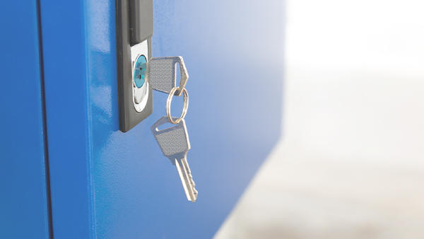 A small set of keys hanging from the lock of a blue locker