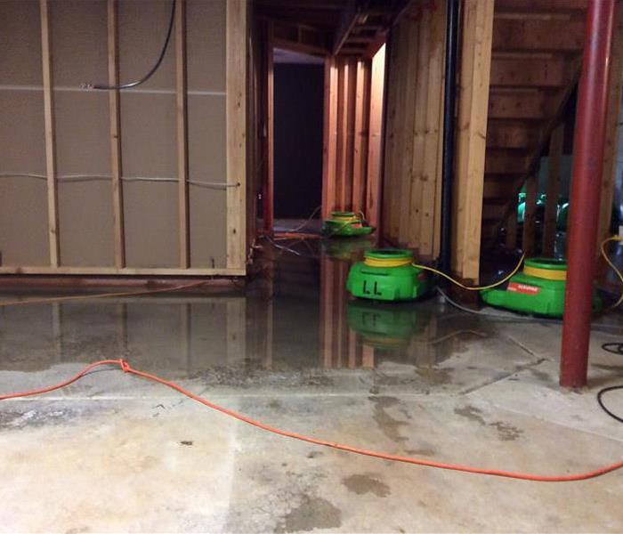 The water damage in this Chicago home depicted in this photo resulted from a large water pipe springing a large leak. SERVPRO of West Loop/Bucktown/Greektown removed the damaged flooring and drywall. They quickly set-up their equipment as seen in this picture to began the drying process. SERVPRO of West Loop/Bucktown/Greektown moves fast to correct the fire, water or mold problems with which our clients are confronted. Call the professionals at (773) 434-9100 any time, day or night. We are here to help.