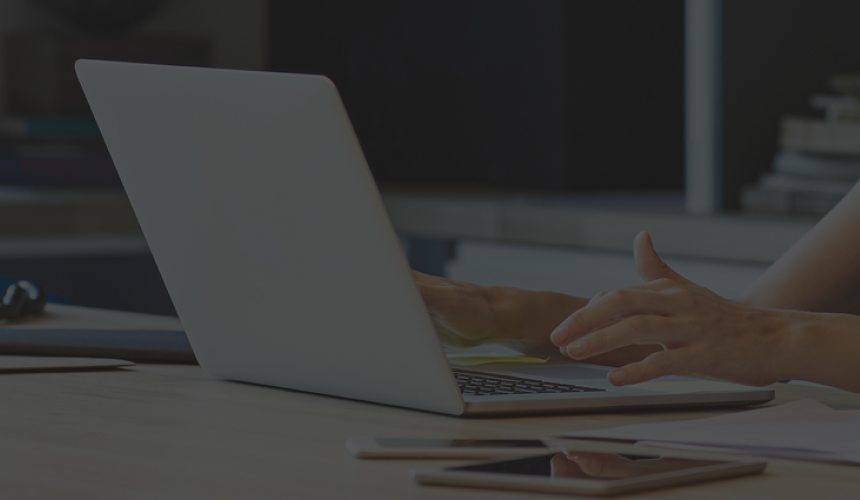 Close-up shot of woman working on her laptop.