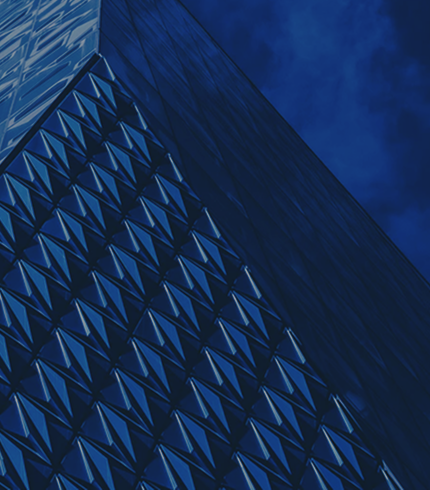 Reflective pyramid-shaped building with angled glass windows.