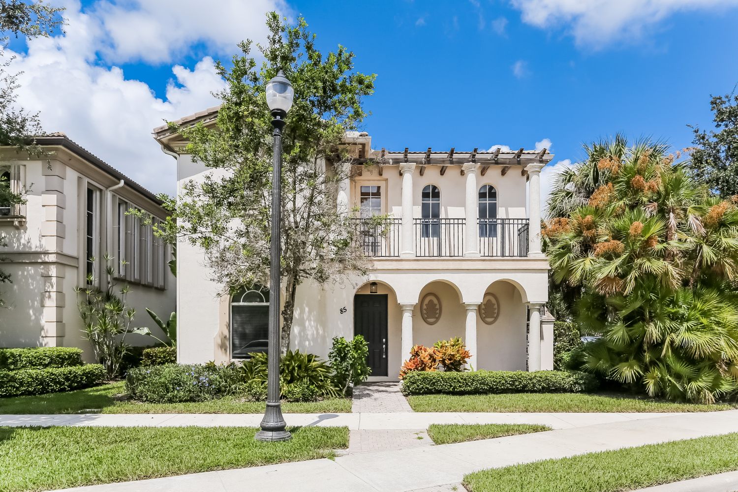 Stunning home with a covered porch and beautiful landscaping at Invitation Homes South Florida.