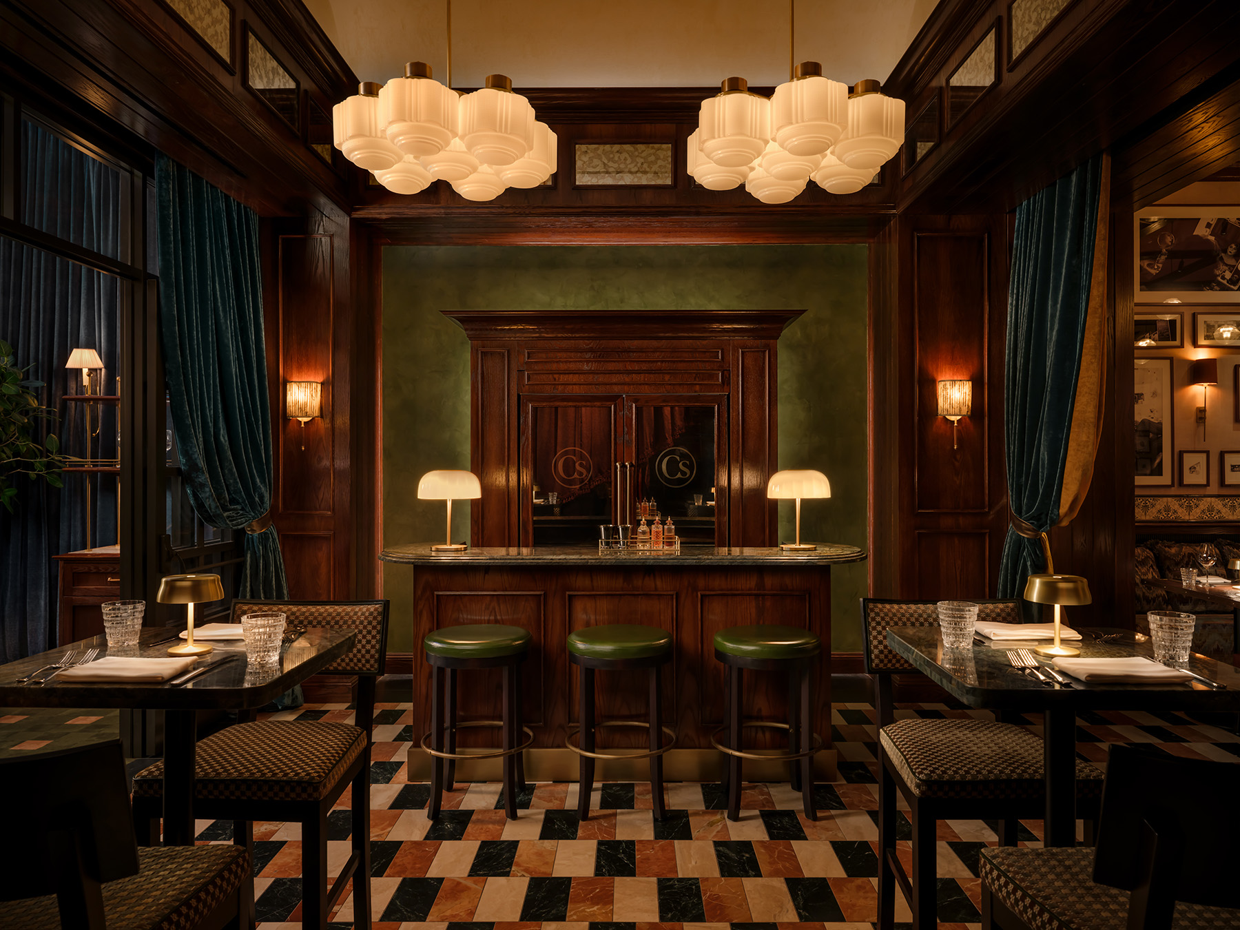 Upscale cocktail bar with green leather stools and wood paneling at Carversteak NYC.