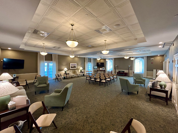 A comfortable reception and visitation room at the Brighton chapel, furnished with upholstered seati 