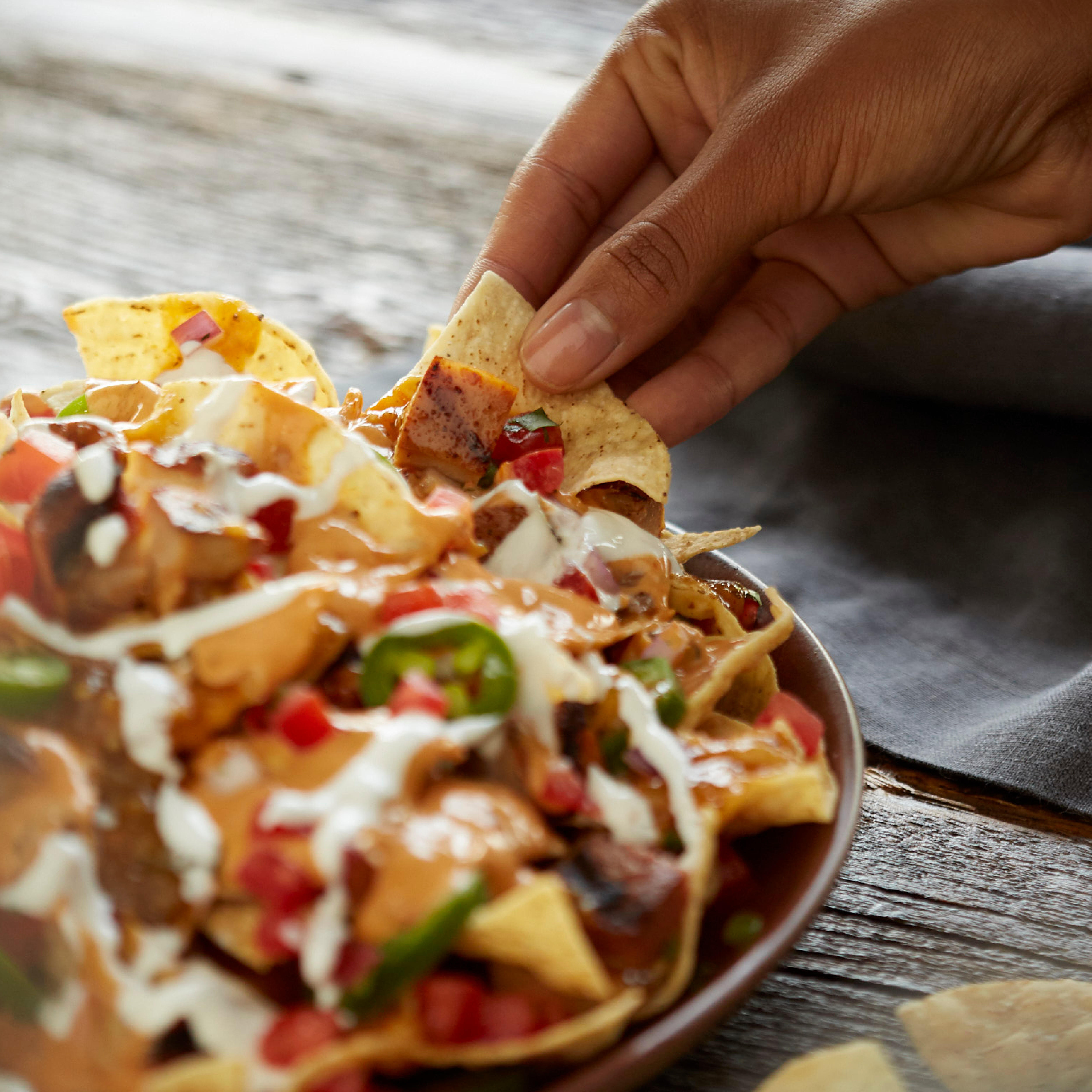 Nachos can be loaded with grilled adobo chicken, house-made pico de gallo and QDOBA's signature 3-ch