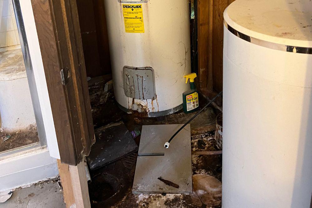 Pictured here is a 20-year-old water heater, the internal tank rusted out completely, and water ran all day when it ruptured.