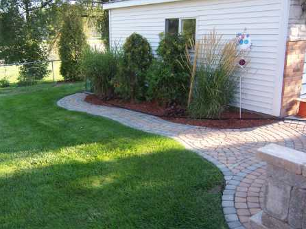 house with landscaping and hardscaping work by M & D Design & Build