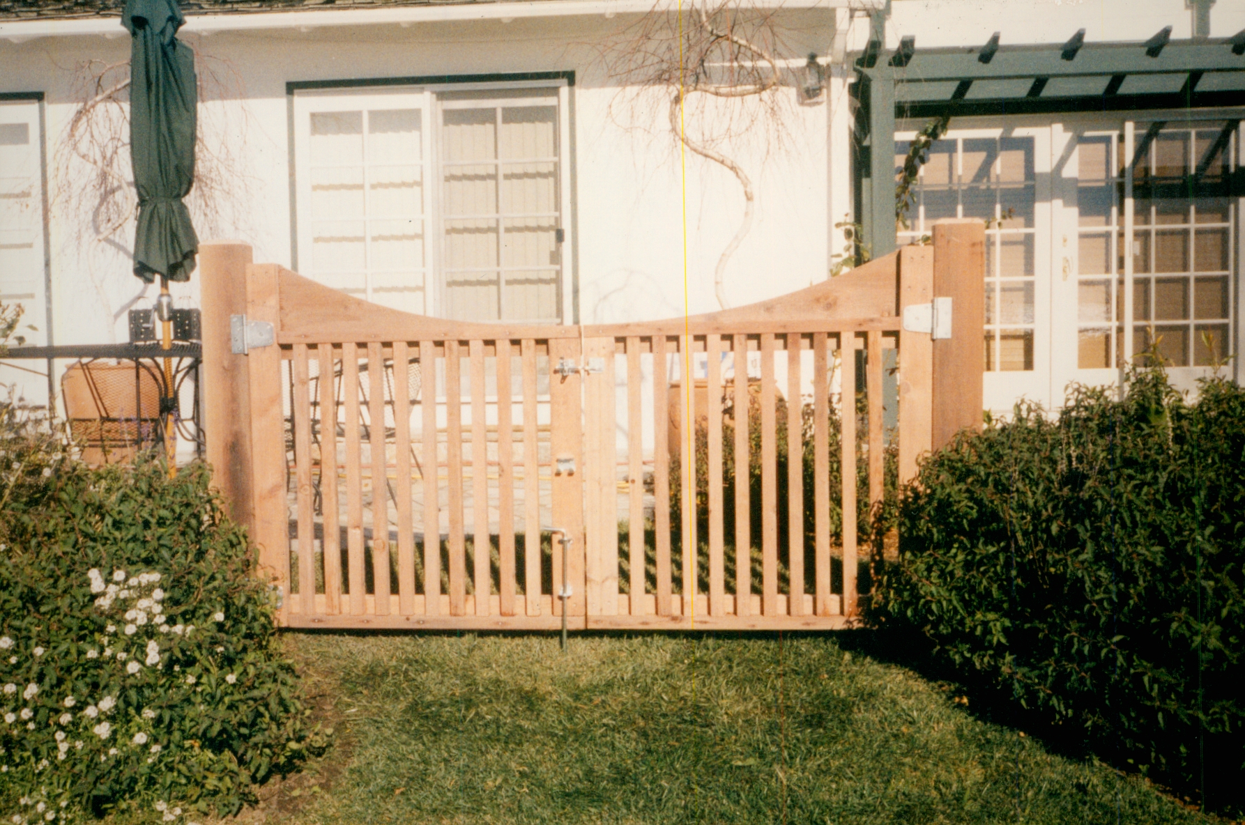 Wood fence and gate installation for a residential front yard, adding privacy, security, and natural curb appeal.