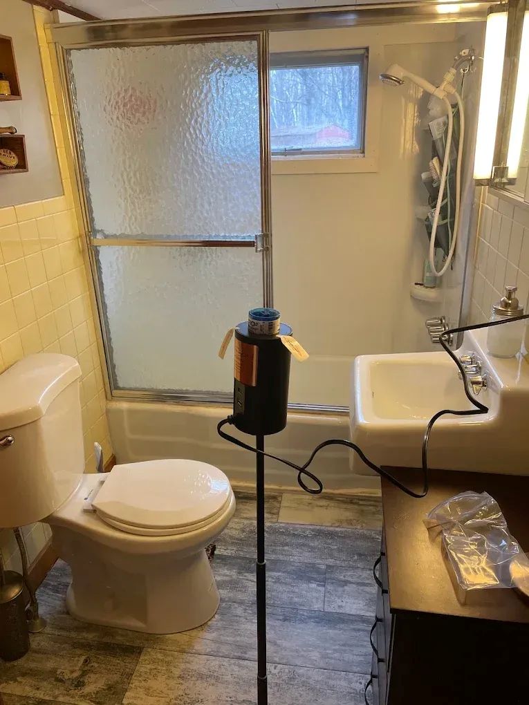 Professional mold testing conducted by Upfront Home Inspection & Maintenance in a residential bathroom in Maine. Specialized air sampling equipment is used to collect samples for evaluating potential airborne mold concerns.