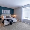 Master bedroom with accent wall and natural light